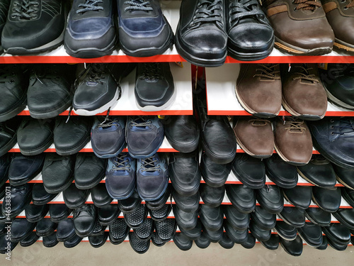 The Sale of footwear. Men's shoe store. Shoe shelves.