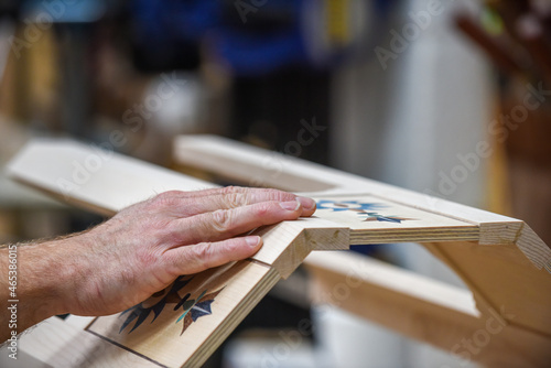 Man with finished product he has made in job as a carpenter photo