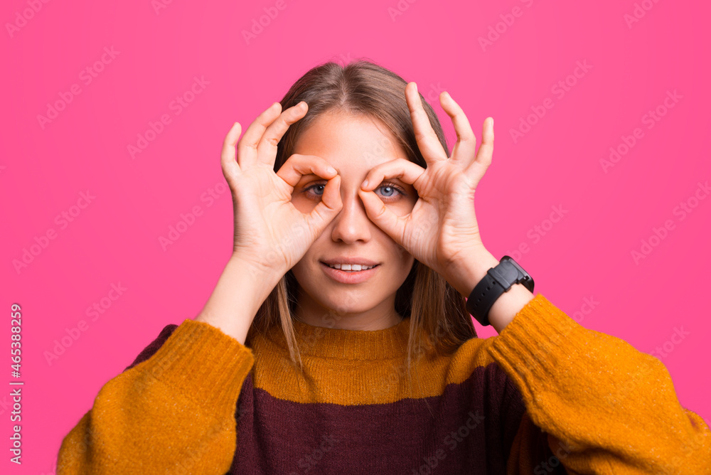 Close up portrait of a woman making binoculars gesture. Close up portrait of a woman making binoculars gesture.