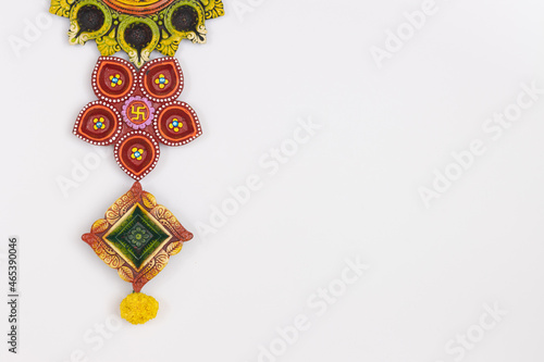 Handmade Handcrafted Eco Friendly earthen Clay Diya Deep Dia with marigold flower arranged as a border background with copy space