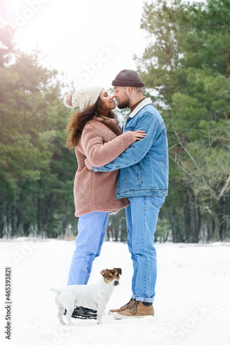 Happy young couple with dog...
