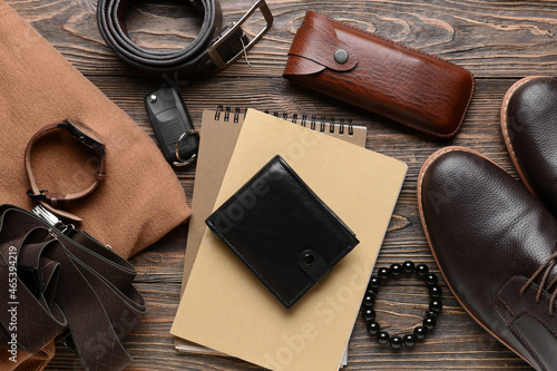 Set of stylish male accessories and clothes on wooden background