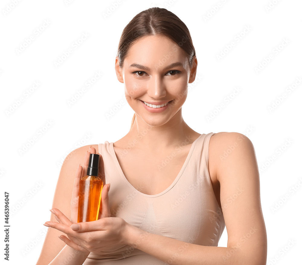 Smiling woman with bottle of essential oil on white background Smiling woman with bottle of essential oil on white background
