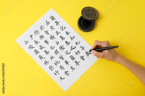 Asian calligraphist writing...