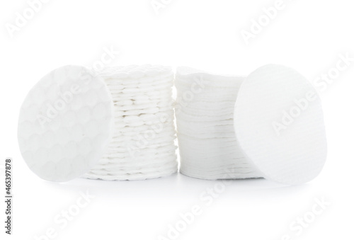 Stacks of clean cosmetic cotton pads on white background