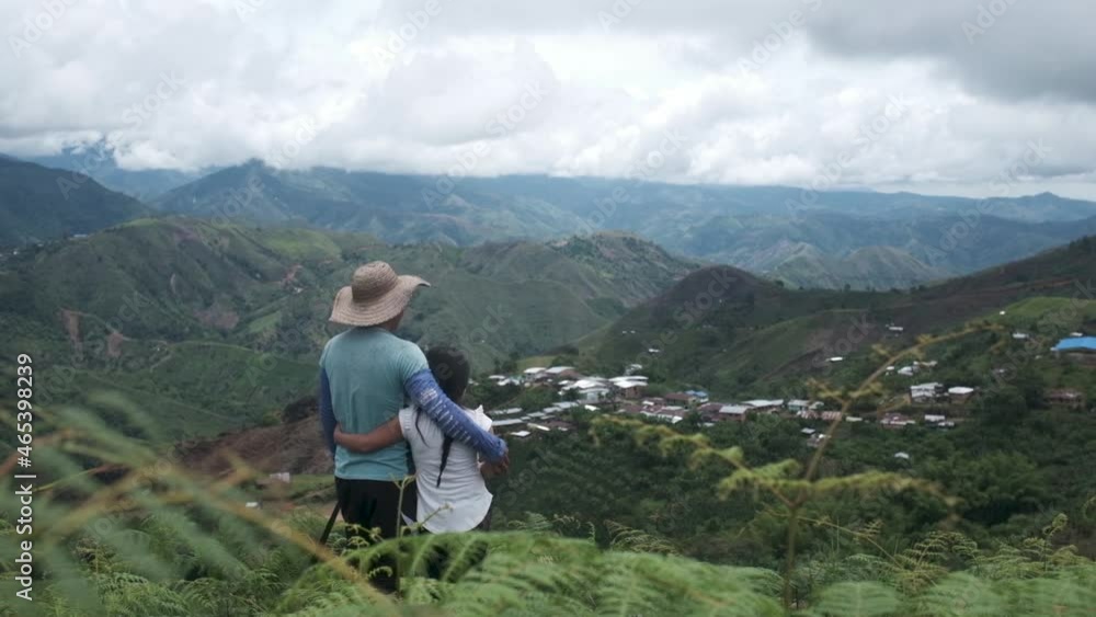 Farmer and daughter hug each other while looking into the fields and mountains Farmer and daughter hug each other while looking into the fields and mountains