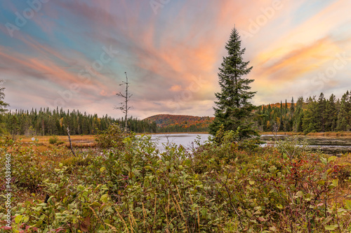 Lac St Michel in Autumn showing fall colors in cottage country, Quebec Canada.