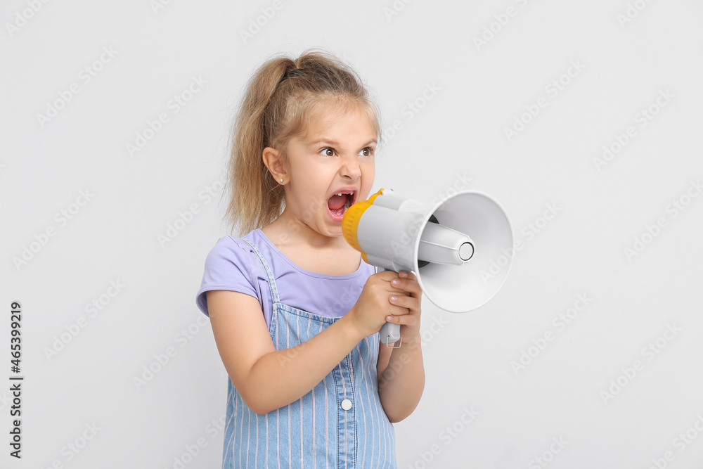 Protesting little girl with megaphone on light background Protesting little girl with megaphone on light background