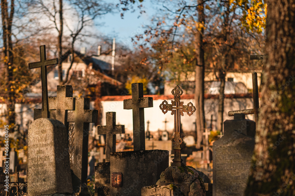Fototapeta premium Crosses on a tombstones at a cemetery in autumn