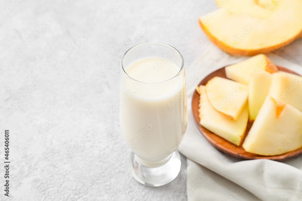 Glass of tasty melon milkshake on light background, closeup Glass of tasty melon milkshake on light background, closeup