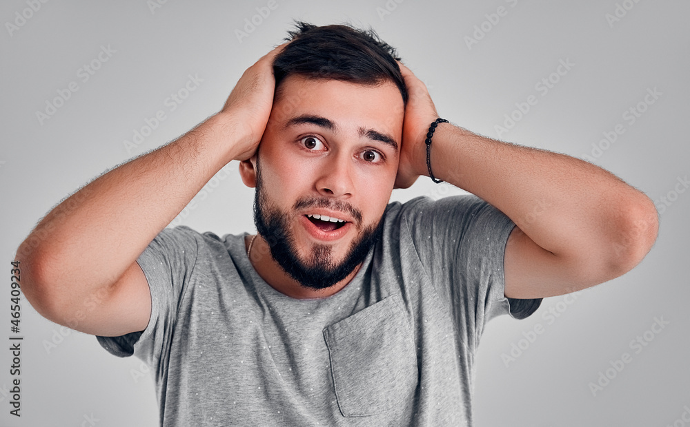 Young man in the studio on a gray background Young man in the studio on a gray background