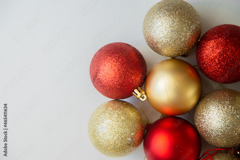Golden and red Christmas balls with and without sequins lie on a white background. High quality photo Golden and red Christmas balls with and without sequins lie on a white background. High quality photo