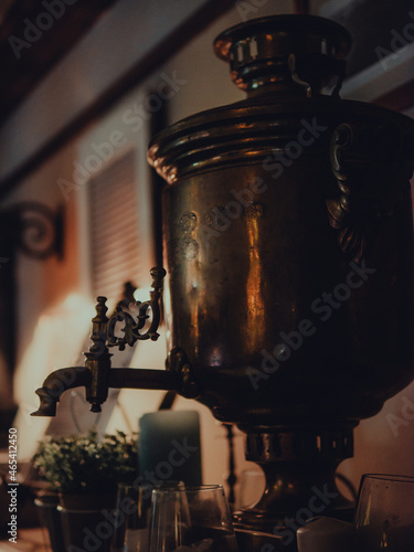 Fototapeta Naklejka Na Ścianę i Meble -  A closeup shot of antique copper samovar in a beautiful interior setting