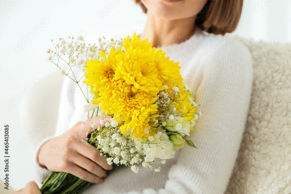 Beautiful young woman with bouquet of flowers sitting in armchair on white background Beautiful young woman with bouquet of flowers sitting in armchair on white background