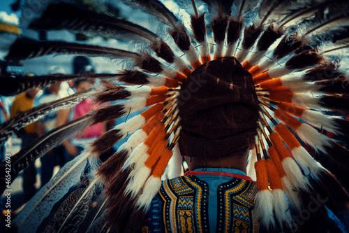 native american chief with colorful feather head dress attire