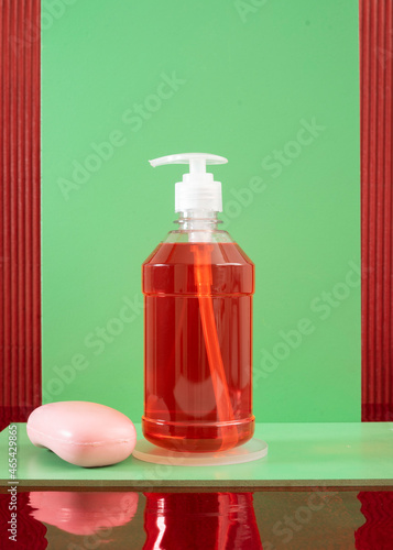 Plastic bottle of liquid red soap