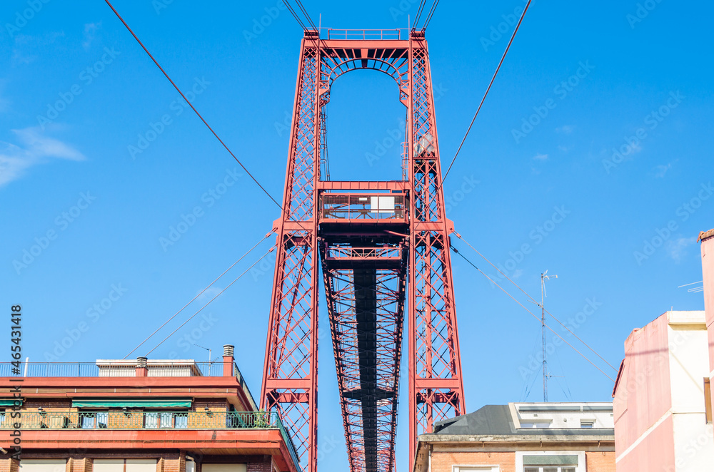 Fototapeta premium Colorful facades in Portugalete old town, with the famous Vizcaya Bridge in the background