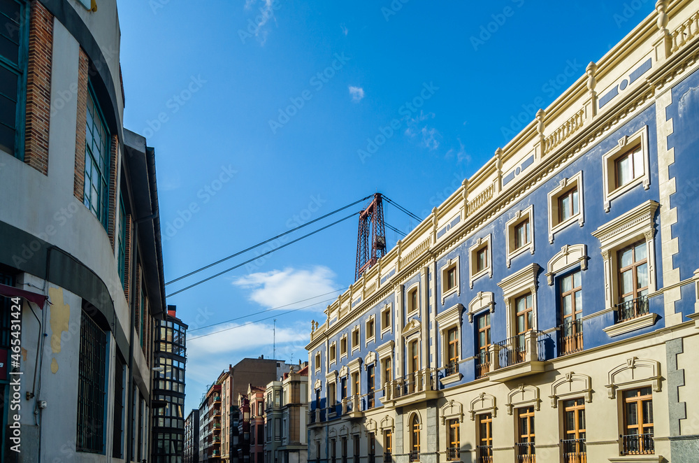 Colorful facades in Portugalete old town, with the famous Vizcaya Bridge in the background