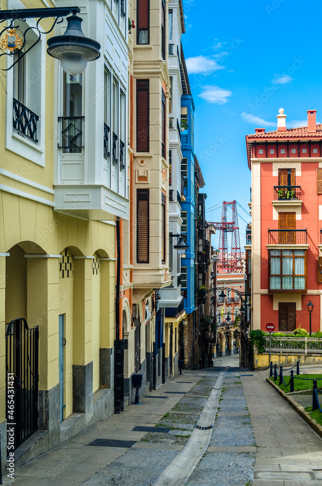 Colorful facades in Portugalete old town, with the famous Vizcaya Bridge in the background
