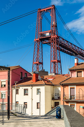 Colorful facades in Portugalete old town, with the famous Vizcaya Bridge in the background © vli86