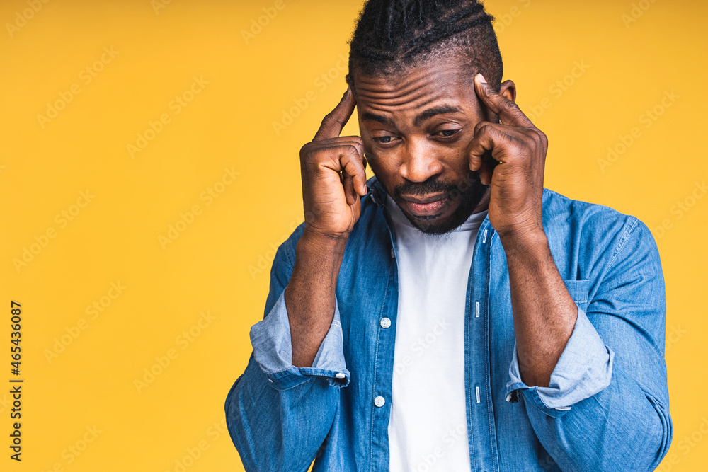 Stressed young african american man feel pain having terrible strong headache concept, tired upset black guy massaging temples suffering from migraine isolated over yellow studio background. Stressed young african american man feel pain having terrible strong headache concept, tired upset black guy massaging temples suffering from migraine isolated over yellow studio background.