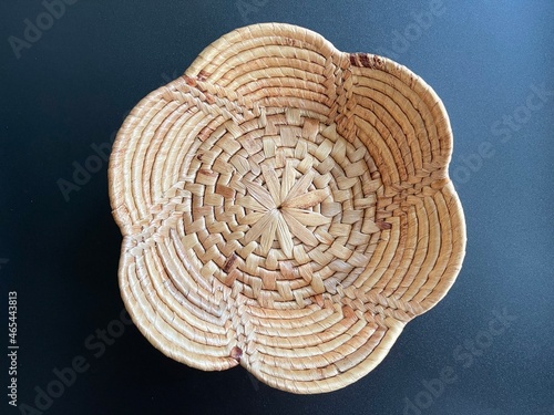 Handmade flower shape basket made from dried water hyacinth, woven basket for home use and decoration, weaved basket on black background