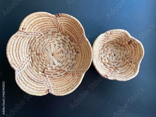 Handmade flower shape basket made from dried water hyacinth, woven basket for home use and decoration, weaved basket on black background