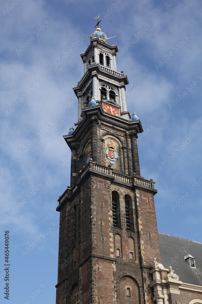 a historical clock tower and winter blue sky in amstedam