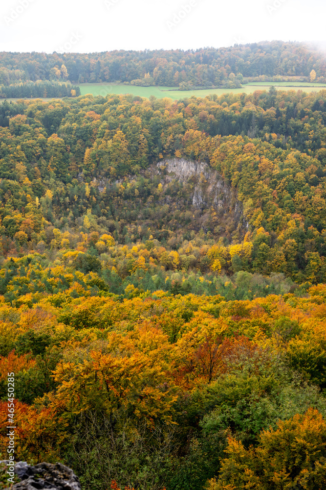 View of mountains and valleys with rocks and forest in bright autumn colors at Gößweinstein, Franconian Switzerland, Germany