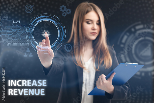 Business, Technology, Internet and network concept. Young businessman working on a virtual screen of the future and sees the inscription: Increase revenue