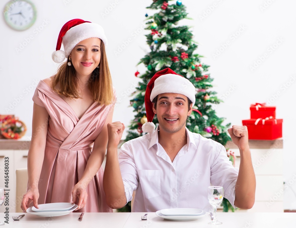 Fototapeta premium Young couple preparing for christmas meal