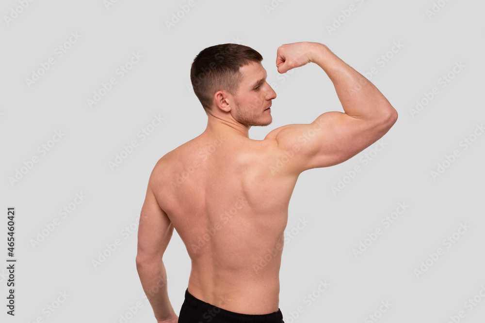 Man Showing Biceps. Sportsman Showing Muscles. ABS, Biceps Muscles. Sports man Flexing Muscles. Topless Pose