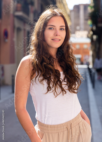 Portrait of cheerful woman standing on a city street