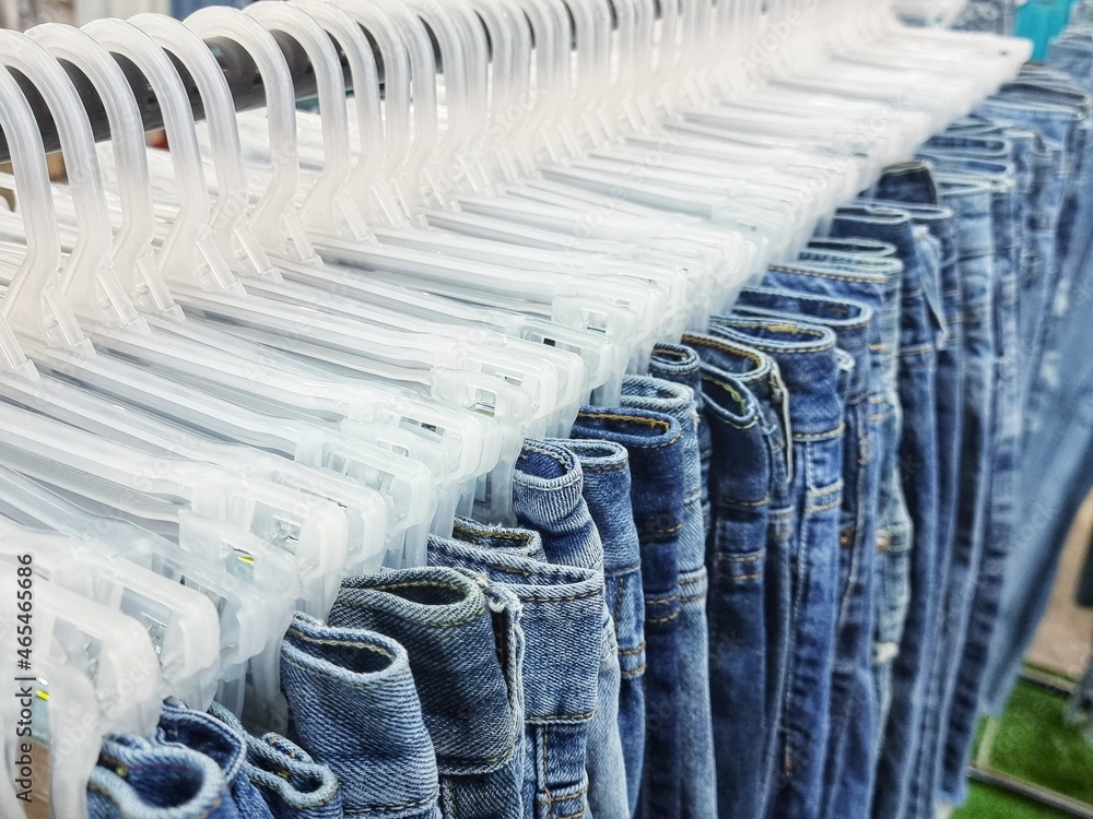 Fototapeta premium Second-hand clothes are neatly folded and hung at a market in Thailand. selection focus.