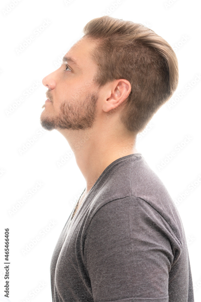 Obraz premium Portrait of a young man with a fashionable haircut on a white background