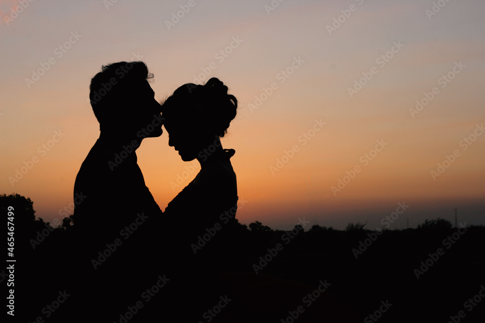 silhouette of a romantic young couple on the beach
