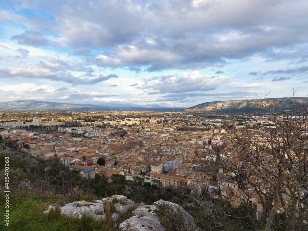Town of Cavaillon in the Vaucluse in Provence in France under a nice cloudy sky from the hill of Saint-Jacques which overlooks the town 