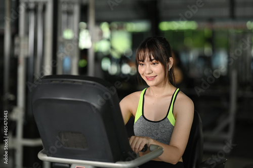 Beautiful fitness woman working out in sport gym.