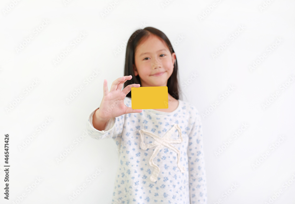 Asian little girl child showing blank yellow card on white background. Focus at card in his hand. Asian little girl child showing blank yellow card on white background. Focus at card in his hand.