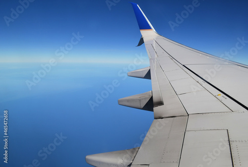 Aerial view of the ocean from a plane window with wing