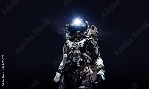 Astronaut in suit against black background. Space technology concept