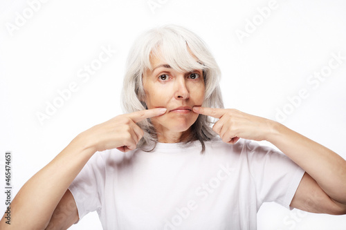 Grandmother with funny expressions isoltaed on white background photo
