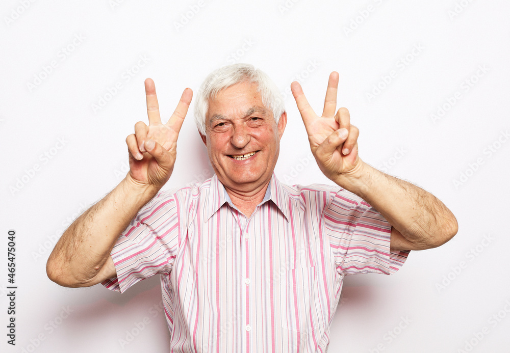 Portrait of his he nice cheerful cheery confident grey-haired man showing double v-sign Portrait of his he nice cheerful cheery confident grey-haired man showing double v-sign