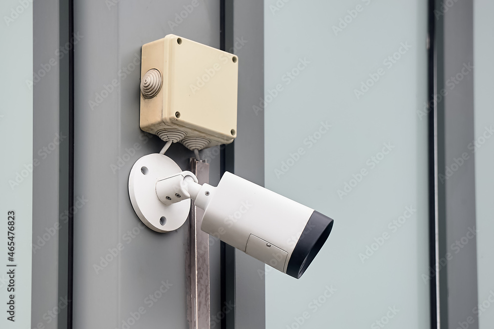 A video surveillance camera hangs on a metal profile A video surveillance camera hangs on a metal profile