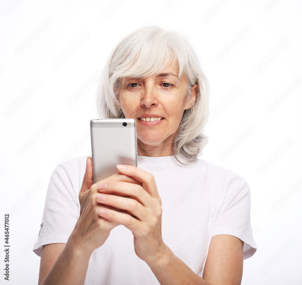 Lovely senior lady in casual outfit cheerfully smiling and looking at camera Lovely senior lady in casual outfit cheerfully smiling and looking at camera