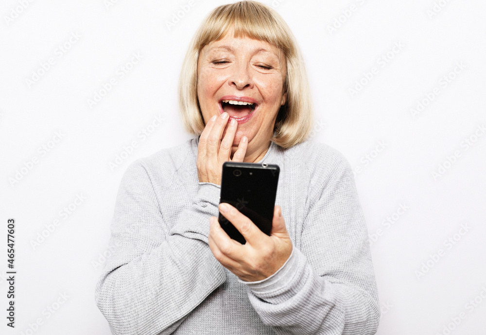 Image of a happy surprised shocked old woman using mobile phone. Image of a happy surprised shocked old woman using mobile phone.