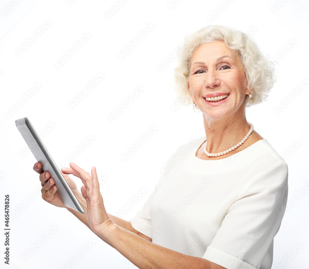 lifestyle, technology and old people concept: Happy mature woman using a tablet over white background lifestyle, technology and old people concept: Happy mature woman using a tablet over white background