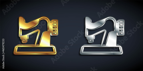 Gold and silver Sewing machine icon isolated on black background. Long shadow style. Vector