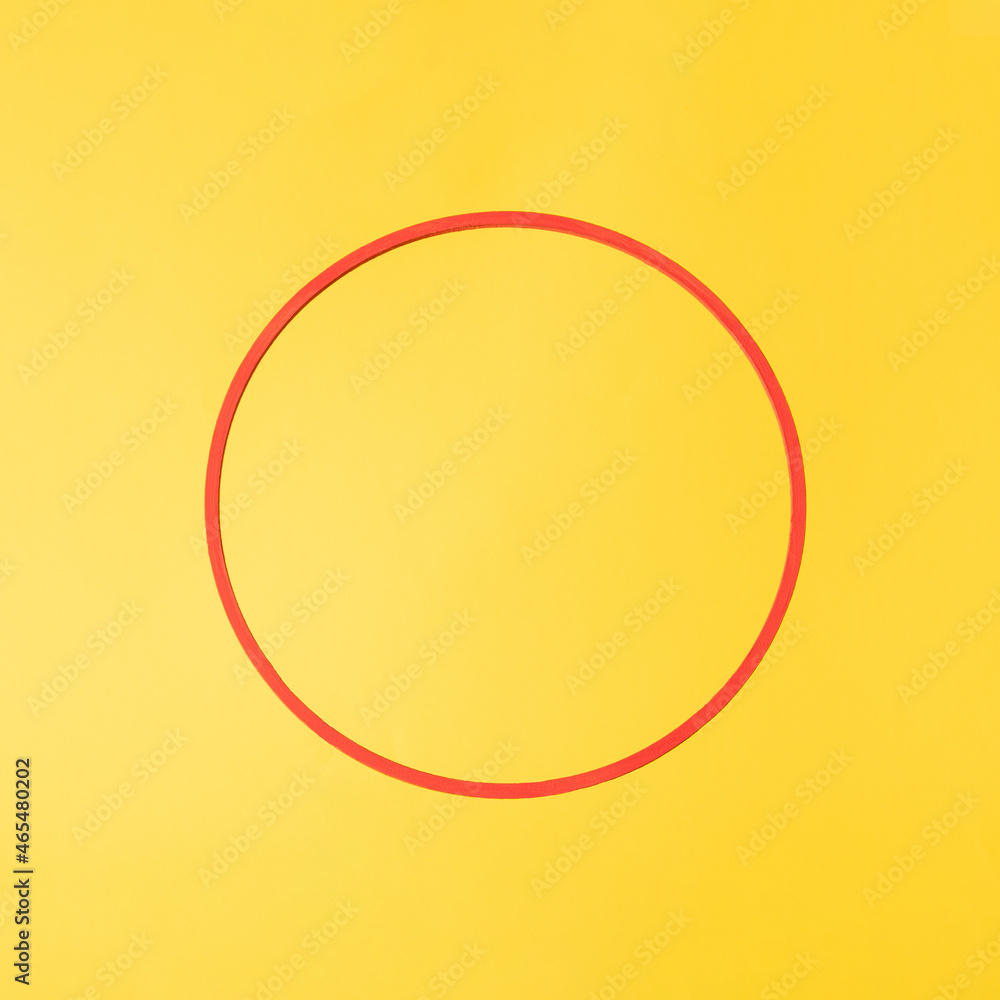 red circle with copyspace against yellow illuminating background. minimalism
