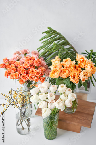 Set of white, green and orange flowers for Interior decorations. The work of the florist at a flower shop. Fresh cut flower. photo